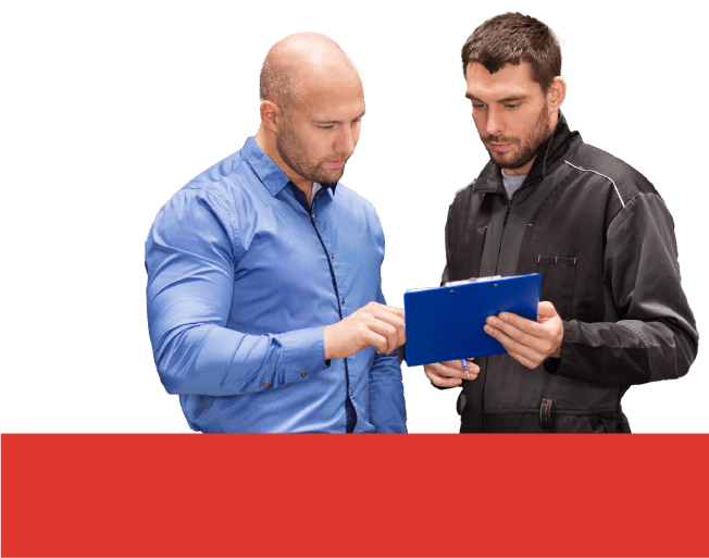 A bald customer in a blue longsleeve and an auto mechanic in a black suit show the customer the list written on a clipboard.